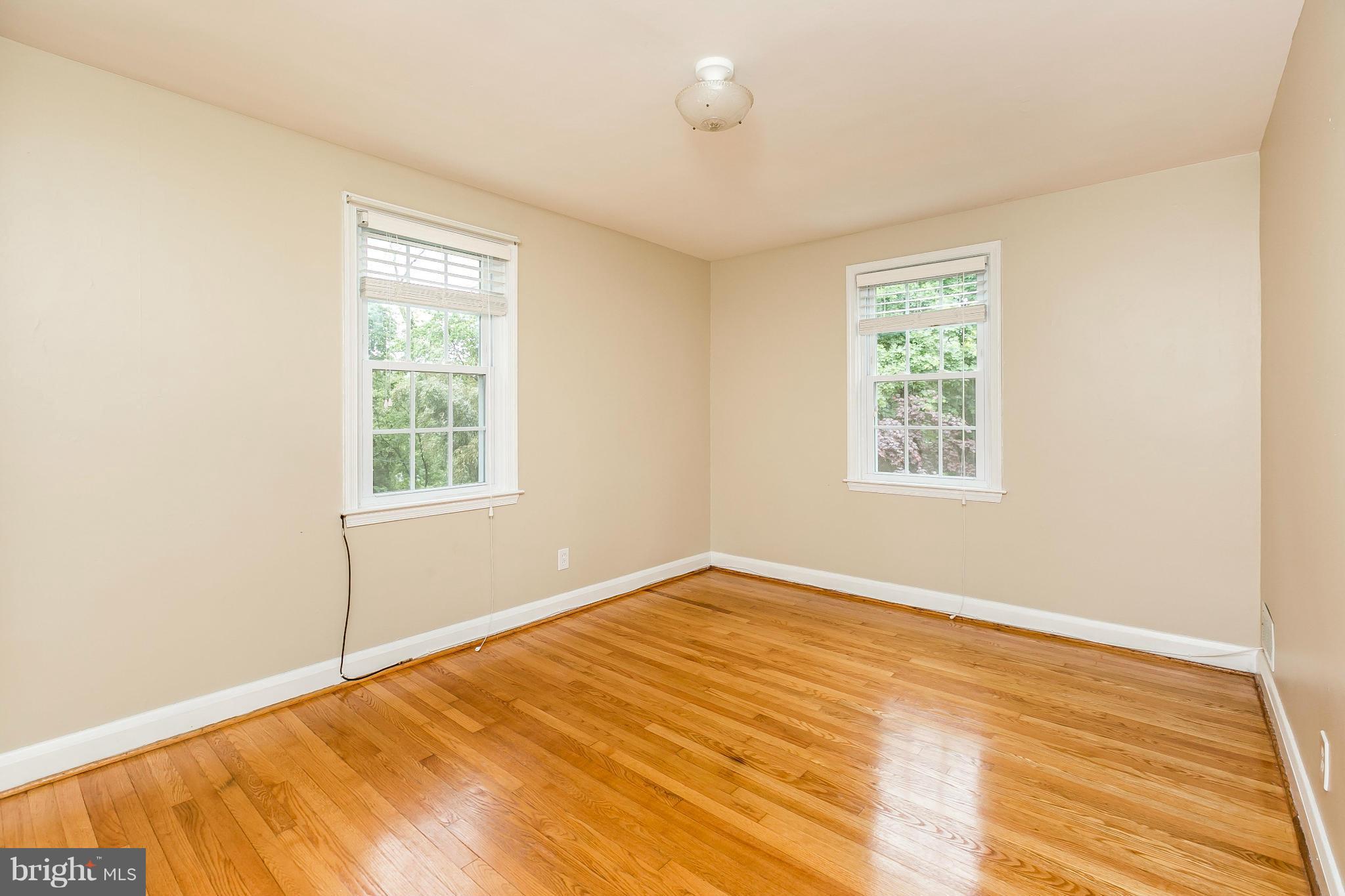 120 Stanmore Road Baltimore, MD 21212 - Photo 14 of 27 an empty room with wooden floor and windows