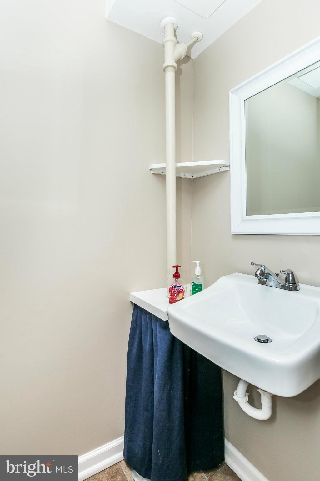 120 Stanmore Road Baltimore, MD 21212 - Photo 23 of 27 a bathroom with a sink and a mirror