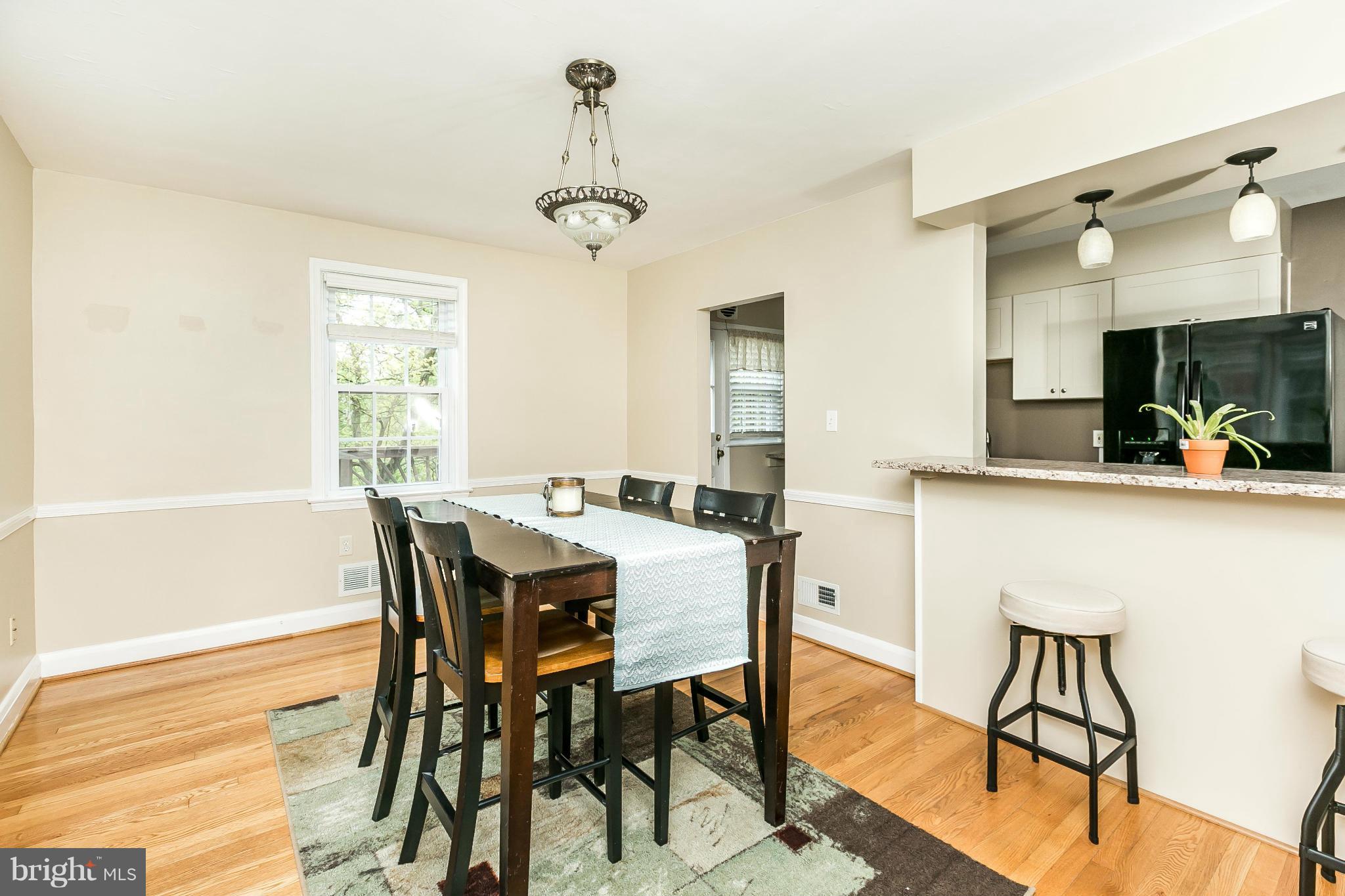 120 Stanmore Road Baltimore, MD 21212 - Photo 9 of 27 a view of a dining room with furniture and a chandelier