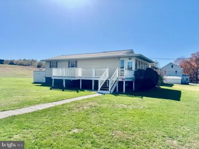 a view of a house with a yard and sitting area
