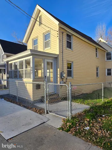 a view of a house with a small yard and potted plants