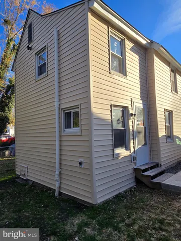 a view of a house with a yard and furniture
