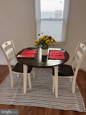 a view of a dining room with furniture and window