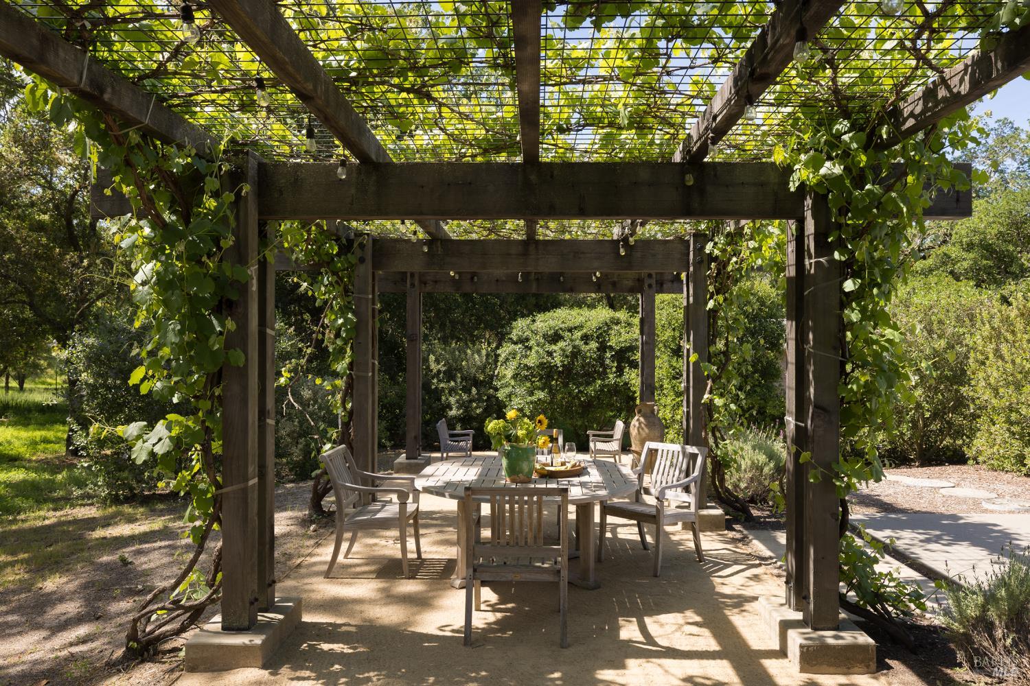 3525 Wood Valley Road Sonoma, CA 95476 - Photo 28 of 39 a view of a patio with table and chairs and floor to ceiling window