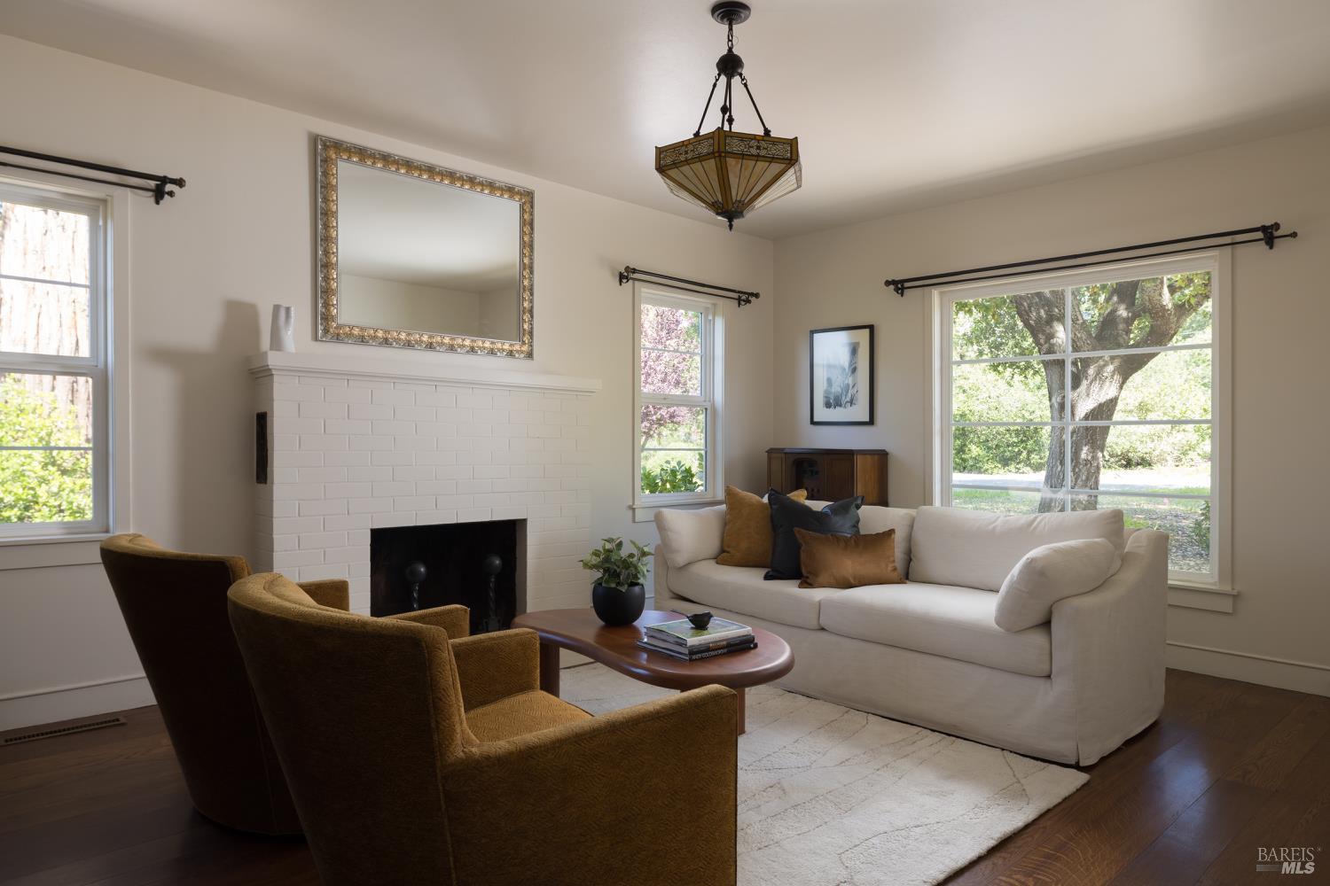 3525 Wood Valley Road Sonoma, CA 95476 - Photo 33 of 39 a living room with furniture a chandelier and a fireplace