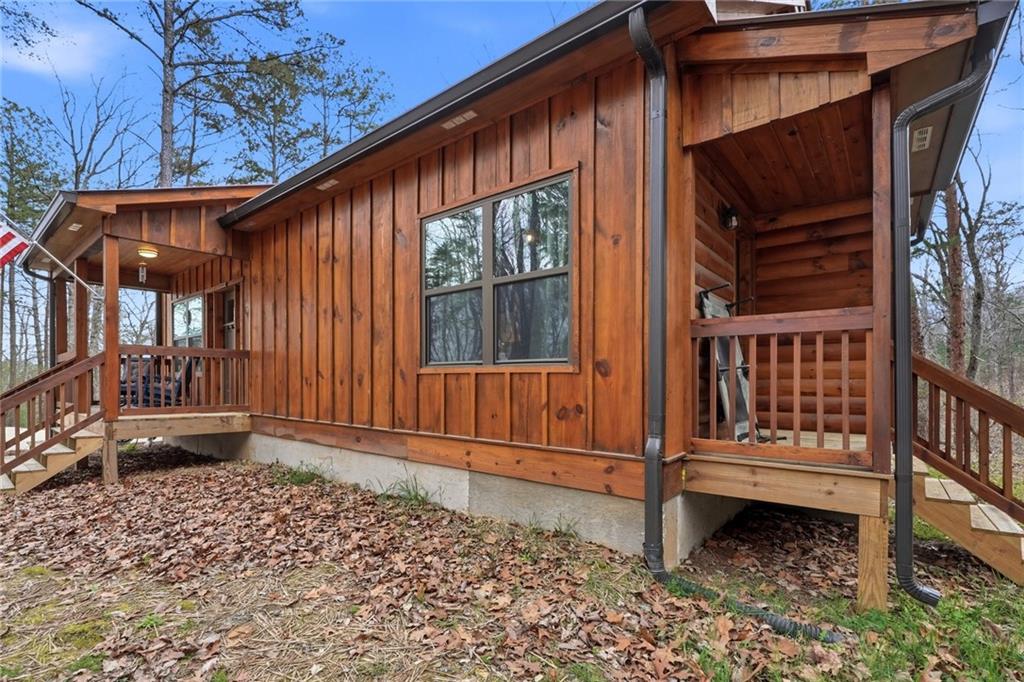 1041 Astro Court Northeast Ranger, GA 30734 - Photo 49 of 52 a porch with a bench next to a yard