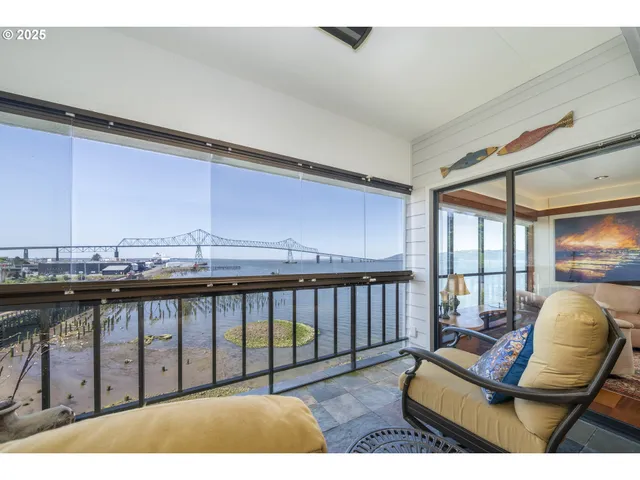 a balcony with wooden floor and outdoor seating