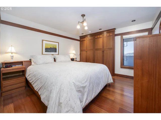 a bathroom with a granite countertop sink toilet and mirror