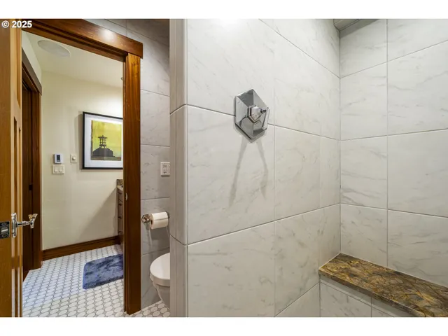 a living room with furniture a flat screen tv and floor to ceiling window