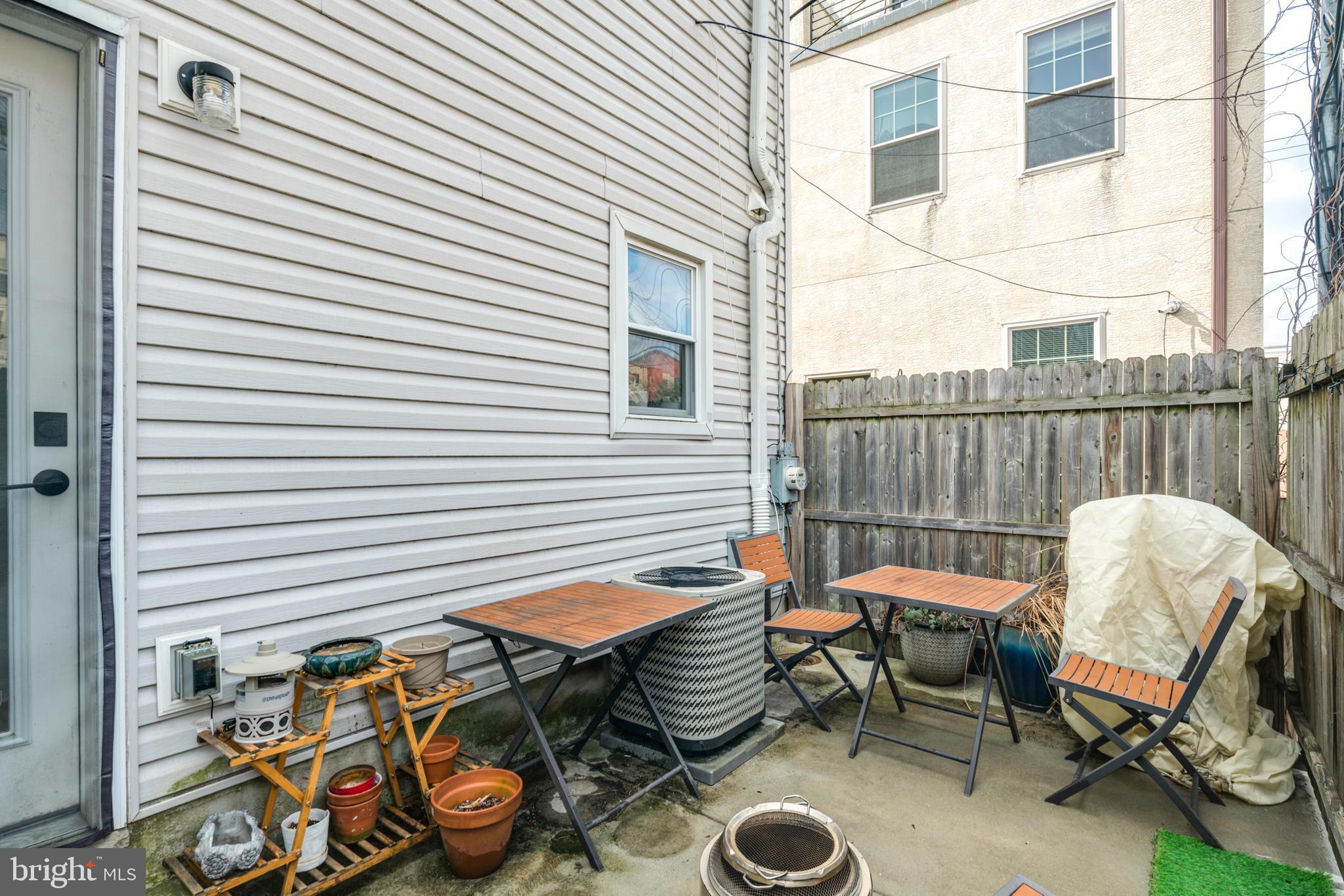 3045 Baltz Street Philadelphia, PA 19121 - Photo 17 of 18 a view of a chairs and table in the back yard of the house