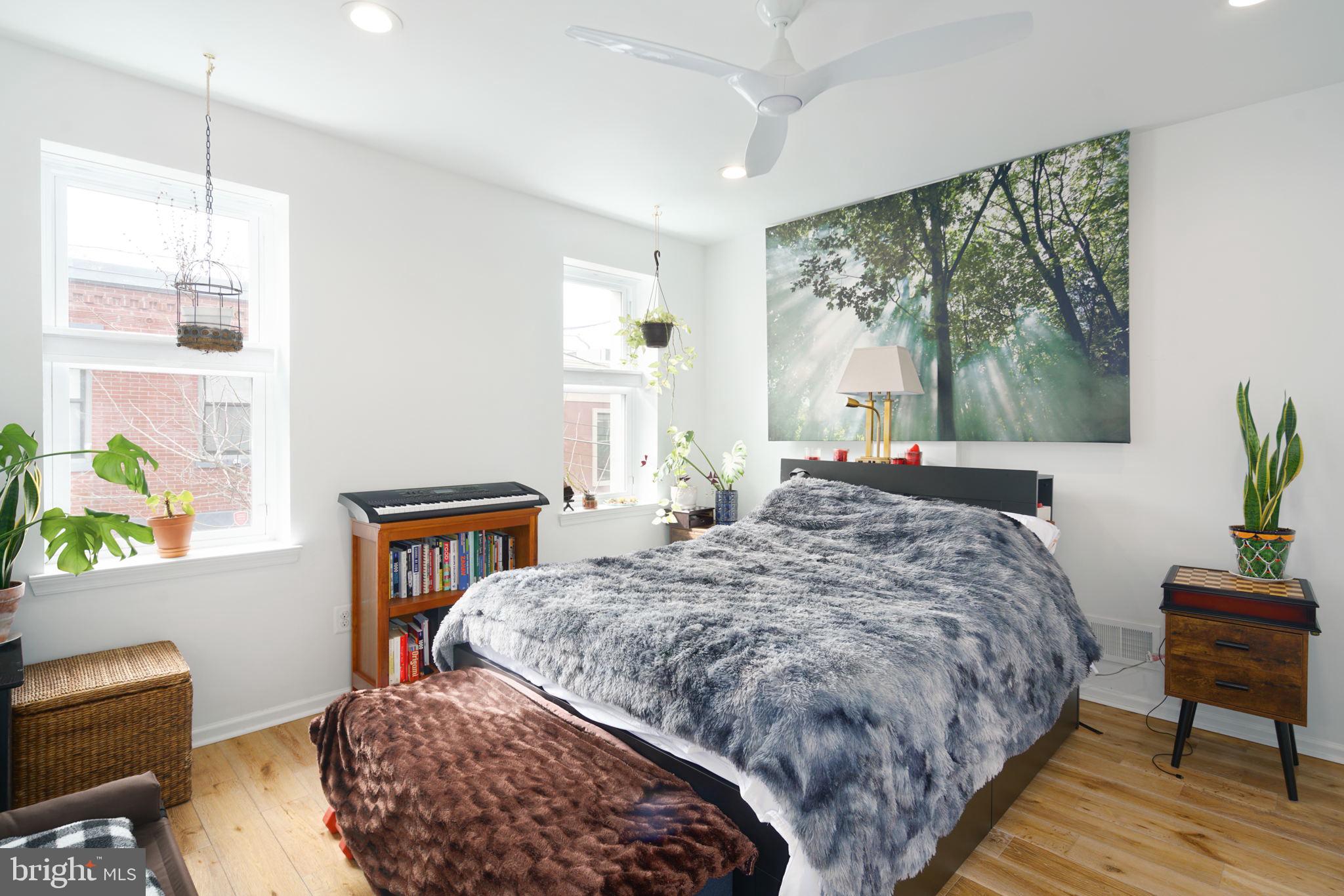 3045 Baltz Street Philadelphia, PA 19121 - Photo 10 of 18 a bedroom with a bed table chair and a window