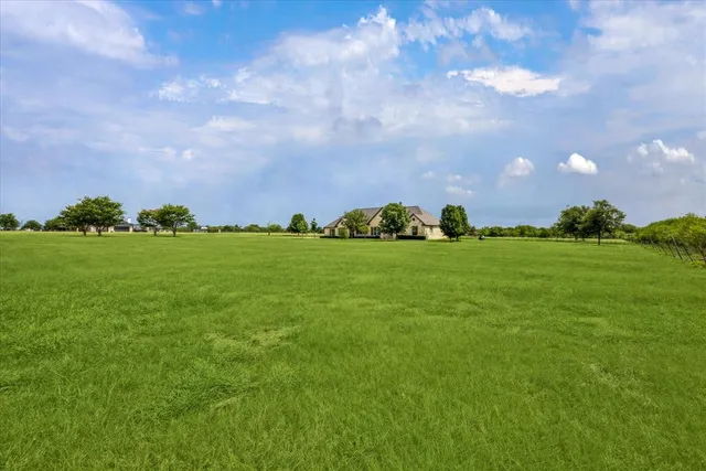 a view of a house with a big yard and garden