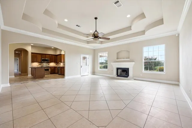 a view of an empty room with a fireplace and a window