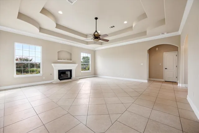 a view of an empty room with a fireplace and a window