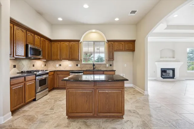 a kitchen with a stove a sink and a microwave