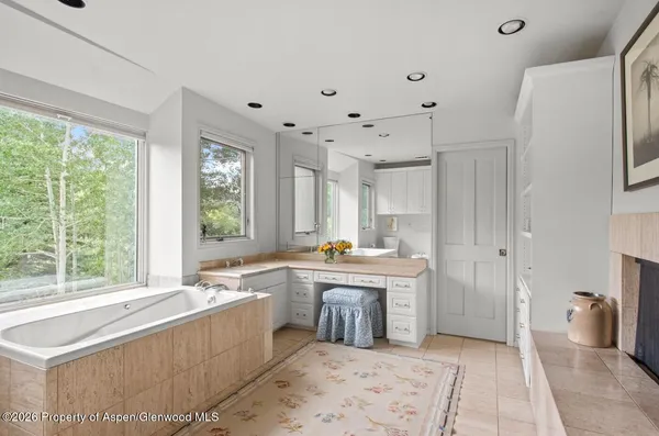 a bathroom with a granite countertop sink mirror and shower