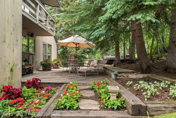 a view of a chairs and table in the patio with a fire pit