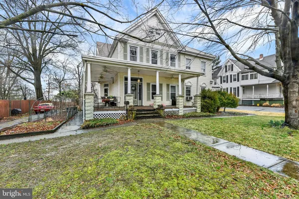a view of a house with backyard porch and sitting area