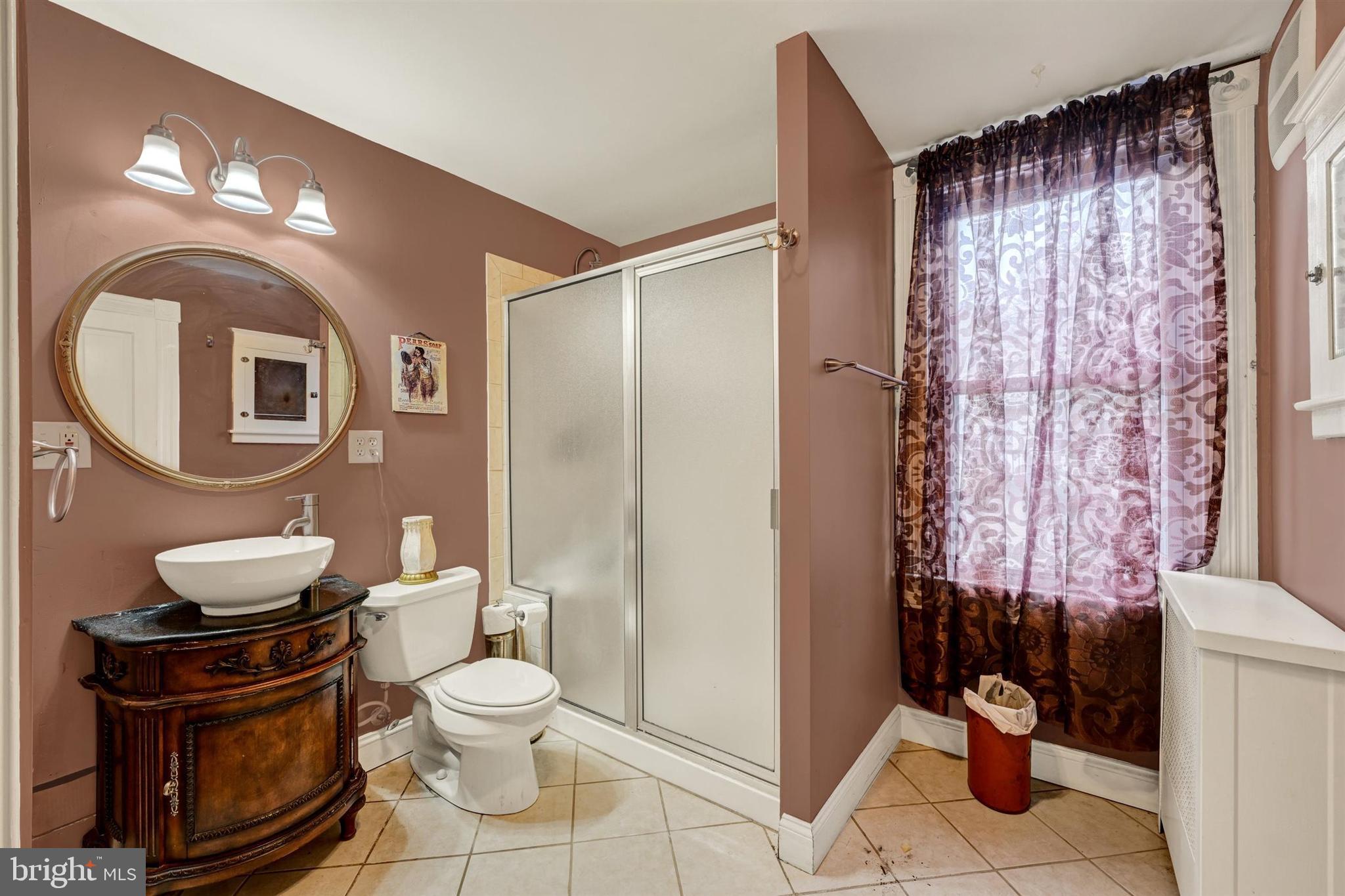 6406 Old Harford Road Baltimore, MD 21214 - Photo 17 of 26 a bathroom with a toilet a sink and a mirror