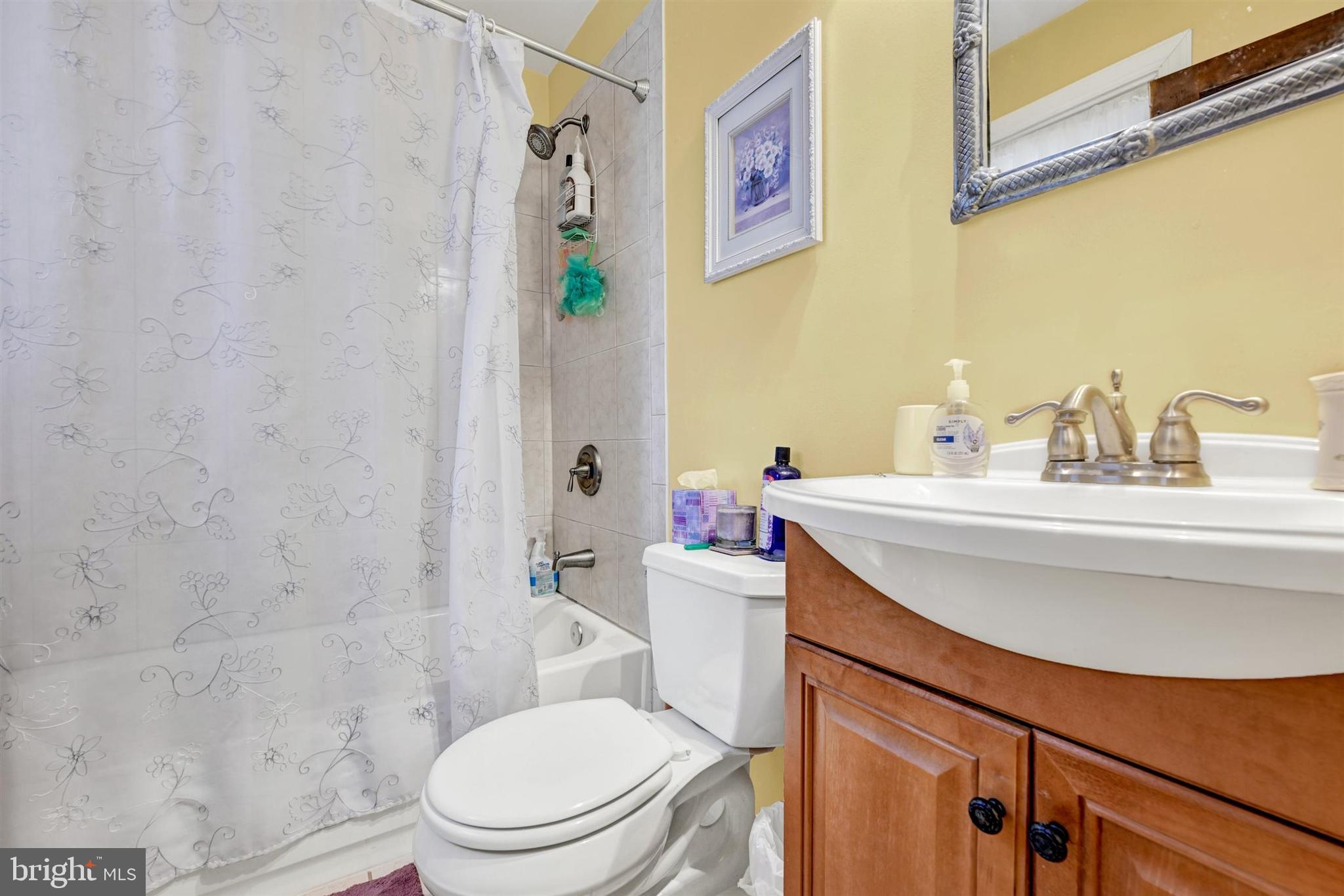 6406 Old Harford Road Baltimore, MD 21214 - Photo 20 of 26 a bathroom with a sink a toilet and shower