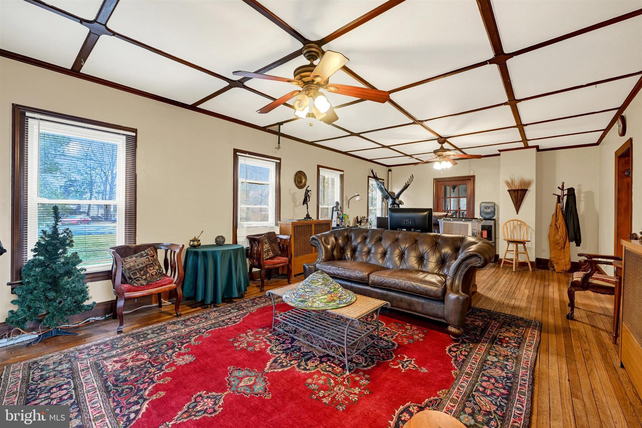 6406 Old Harford Road Baltimore, MD 21214 - Photo 5 of 26 a living room with furniture a couch and paintings on the wall