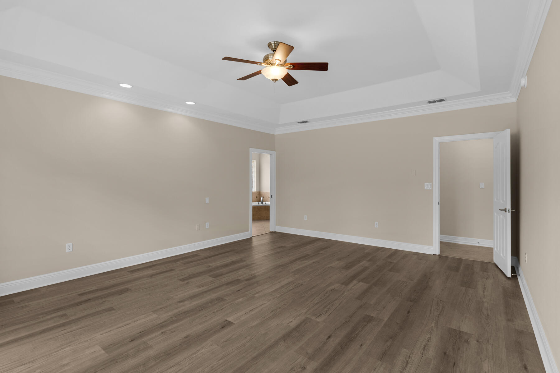 155 Club House Drive East Freeport, FL 32439 - Photo 19 of 34 a view of an empty room with wooden floor and a ceiling fan