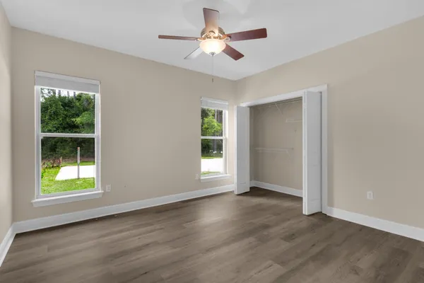 a view of wooden floor and windows in a room