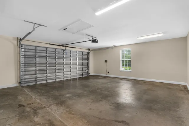 a front view of a house with yard and green space