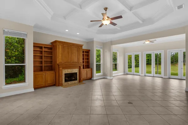 a view of a livingroom with a fireplace window and a fireplace