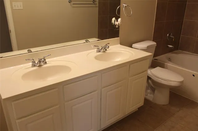 a bathroom with a sink toilet and vanity