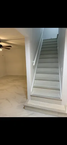 a kitchen with kitchen island a sink a stove and black white cabinets