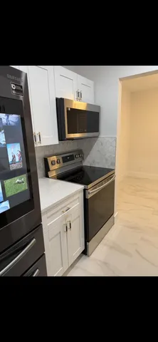 a view of kitchen with stainless steel appliances