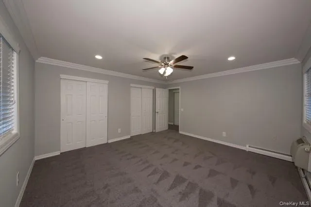 a view of an empty room with a ceiling fan