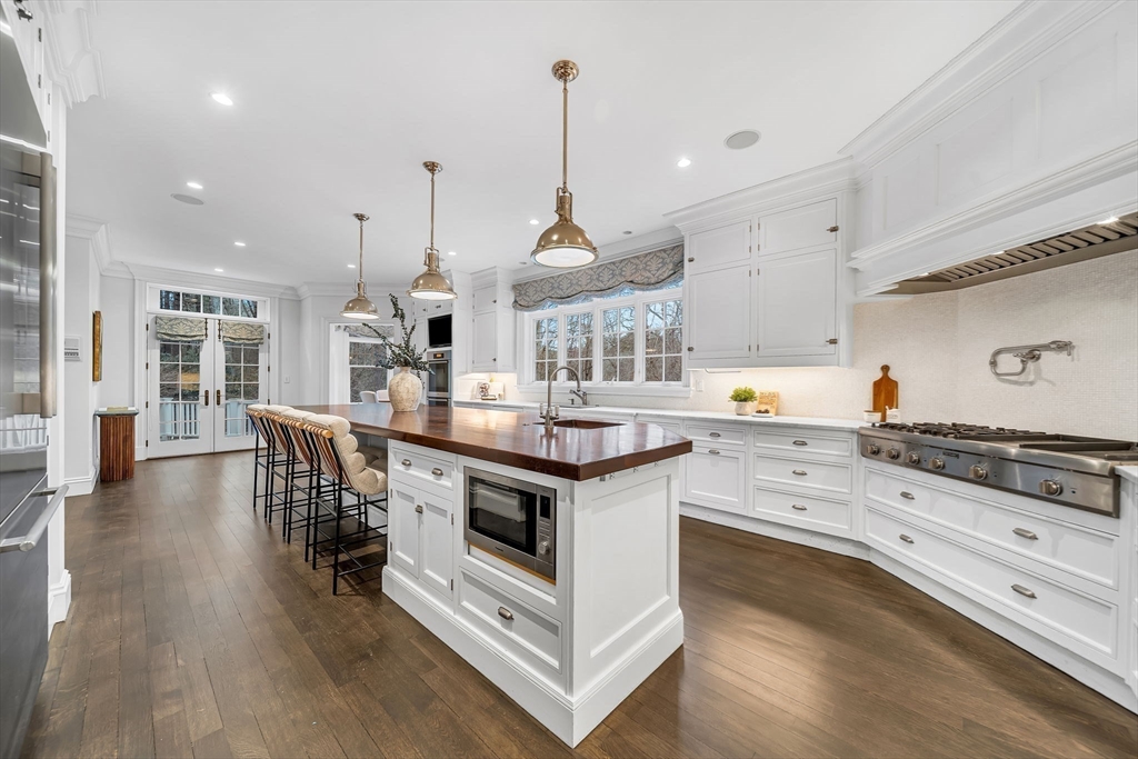 121 Livingston Road Wellesley, MA 02482 - Photo 11 of 38 a kitchen with stainless steel appliances granite countertop a stove oven and a wooden floors