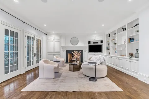 a living room with furniture window and a fireplace