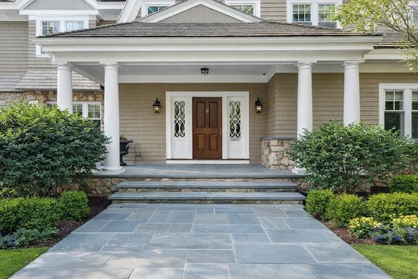 a view of staircase with white walls and mirror