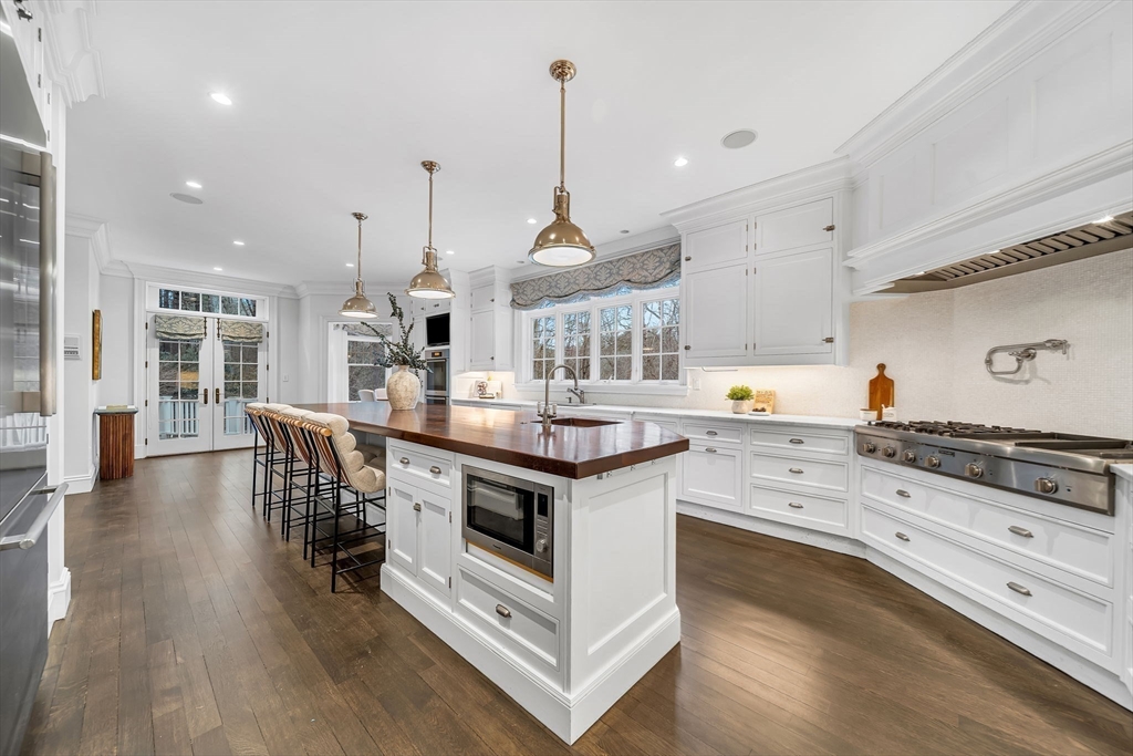 121 Livingston Road Wellesley, MA 02482 - Photo 10 of 37 a kitchen with stainless steel appliances granite countertop a stove oven and a wooden floors