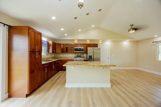 a view of kitchen with refrigerator and microwave