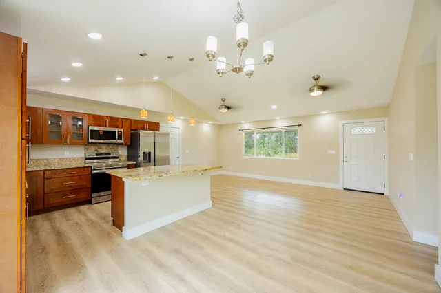 a bathroom with a granite countertop sink a toilet and shower