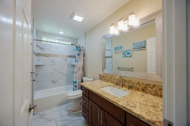 a view of a room with wooden floor and a window