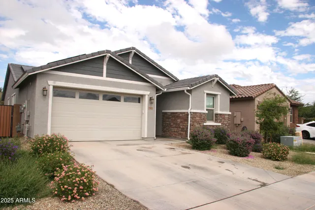 a front view of a house with a garden