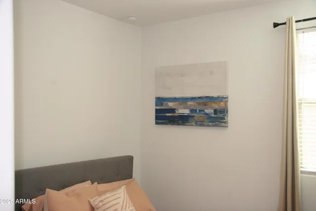 a bedroom with a bed and a cabinet