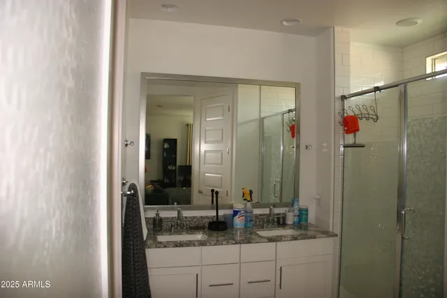 a bathroom with a granite countertop sink and a mirror