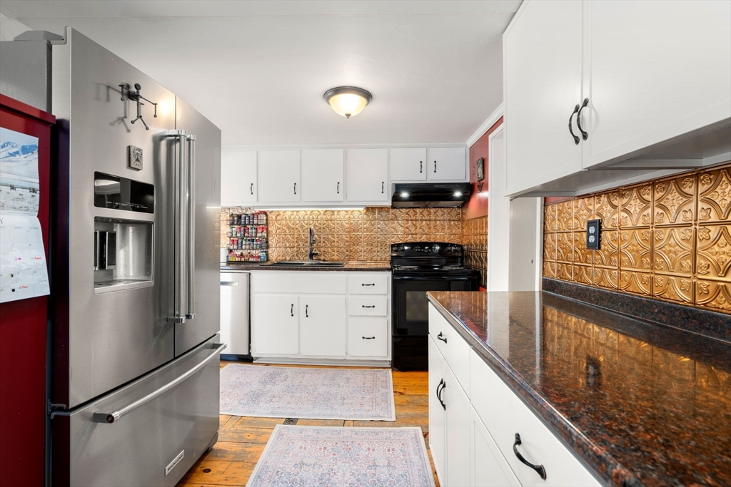 142 Plain Road Wayland, MA 01778 - Photo 3 of 14 a kitchen with stainless steel appliances granite countertop a refrigerator sink and stove