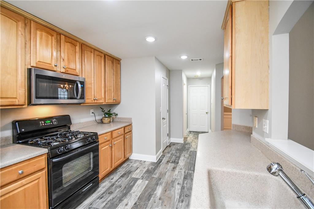 75 Ashebrooke Way Jefferson, GA 30549 - Photo 26 of 84 a kitchen with stainless steel appliances a stove a sink and a microwave