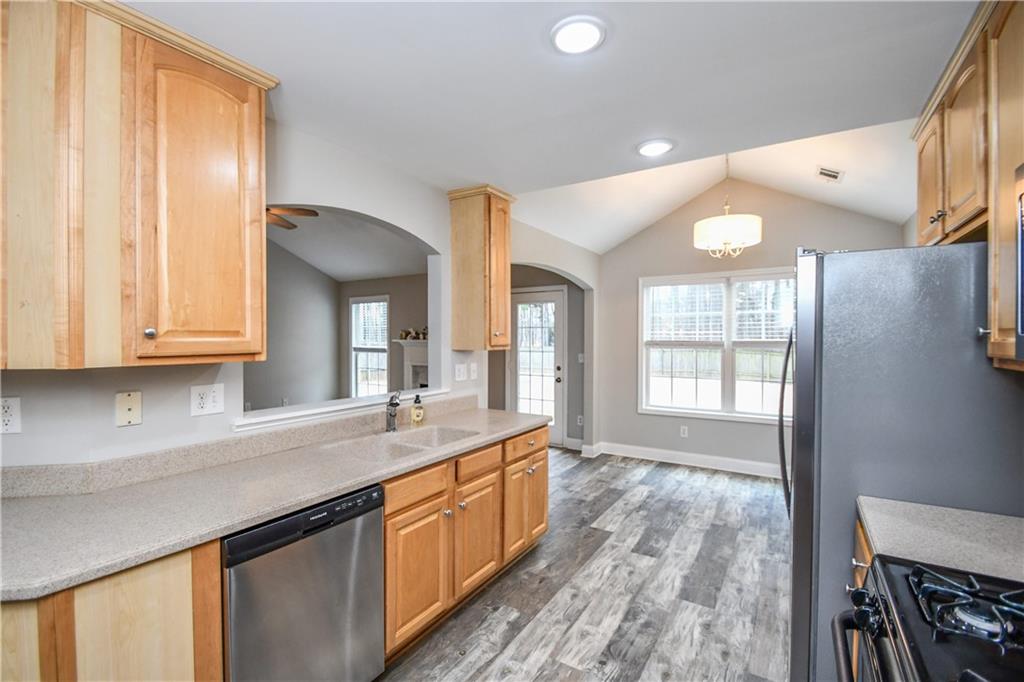 75 Ashebrooke Way Jefferson, GA 30549 - Photo 29 of 84 a kitchen with granite countertop a sink cabinets and wooden floor