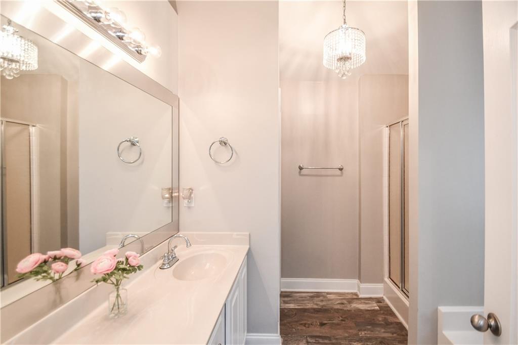 75 Ashebrooke Way Jefferson, GA 30549 - Photo 47 of 84 a bathroom with a granite countertop sink a mirror and shower