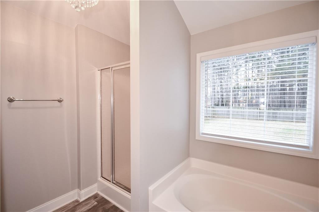 75 Ashebrooke Way Jefferson, GA 30549 - Photo 50 of 84 a bathroom with a bathtub and a window