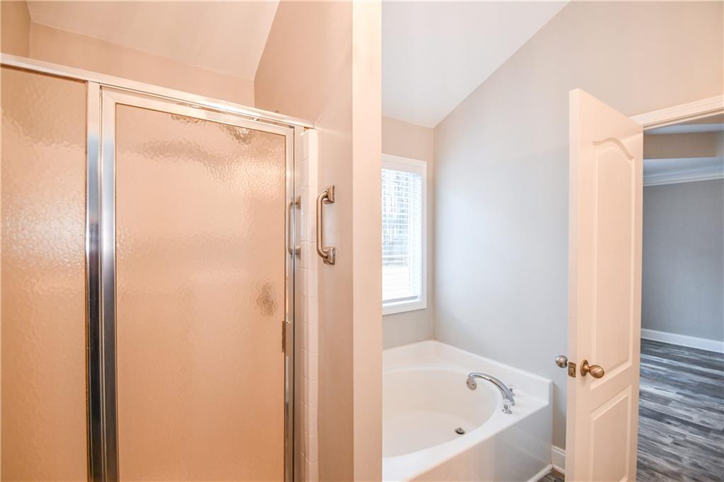 75 Ashebrooke Way Jefferson, GA 30549 - Photo 54 of 84 a bathroom with a bathtub and a shower