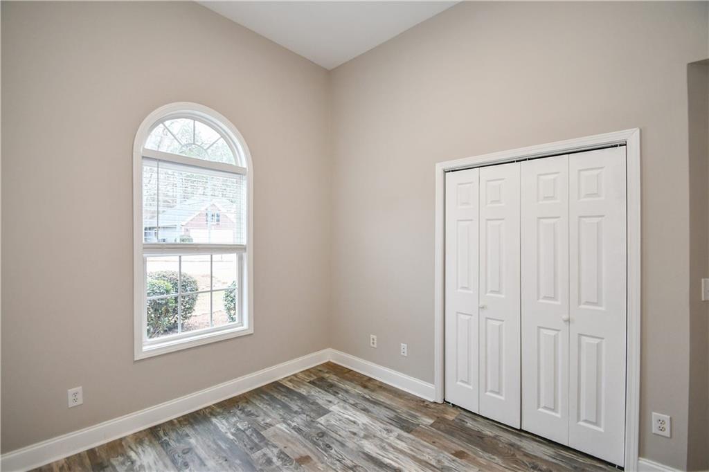 75 Ashebrooke Way Jefferson, GA 30549 - Photo 59 of 84 an empty room with windows mirror and windows